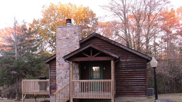 A rustic cabin with a stone chimney, wooden deck, and a porch. - Winetrail Cabin - SIU, Giant City SP, Shawnee Forest, & Cedar Lake minutes away! (Makanda)