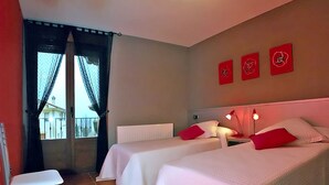 A hotel room with two beds, a chair, and a window with curtains. - Rural house in Navarra for children and dogs for 8-10 people (Eulz)
