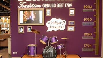 A museum exhibit featuring a drum set and historical timeline of DEINHARD.