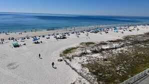 A beach with tents, umbrellas, and a fence. - 🏖️ Wild and free just like the sea🌴 (Gulf Shores)