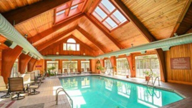 An indoor swimming pool with a high wooden ceiling and large windows. - Summit View Townhouse 1mi to Mt Snow w/ Fireplace! (Dover)