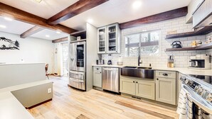A modern kitchen with stainless steel appliances, a dishwasher, and a coffee machine. - Summer in Park City, Dog Friendly, Game Room, Hot Tub, Grill, Playground (Park City)