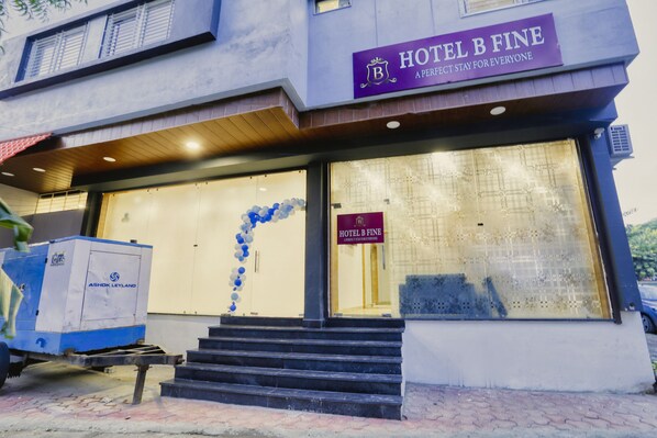 A hotel entrance with a sign reading "HOTEL B FINE" and a decorative blue and white balloon arch. - Hotel B Fine By Aceotel (Indore)