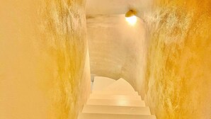 A staircase with white steps leading upwards, surrounded by textured walls. - Villa Alice, Menaggio, Italy (Menaggio)