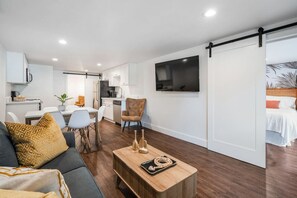 A modern apartment with a living room, kitchen, and bedroom.