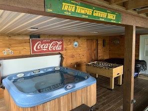 A wooden interior with a hot tub, a foosball table, and a Coca-Cola sign. - JuBela's Cabin + Mountaintop Lake Views + Private Hot Tub + ASKA Trail Access (Blue Ridge)