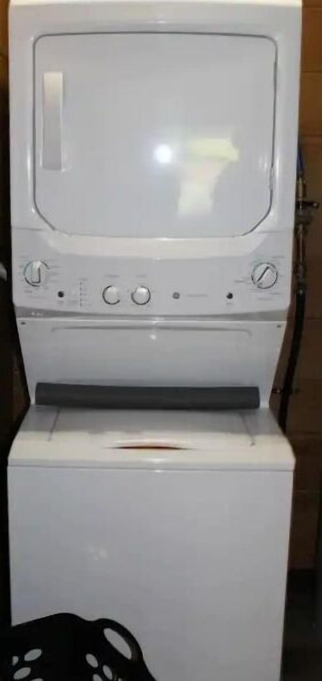 Una lavadora blanca con panel de control y puerta.