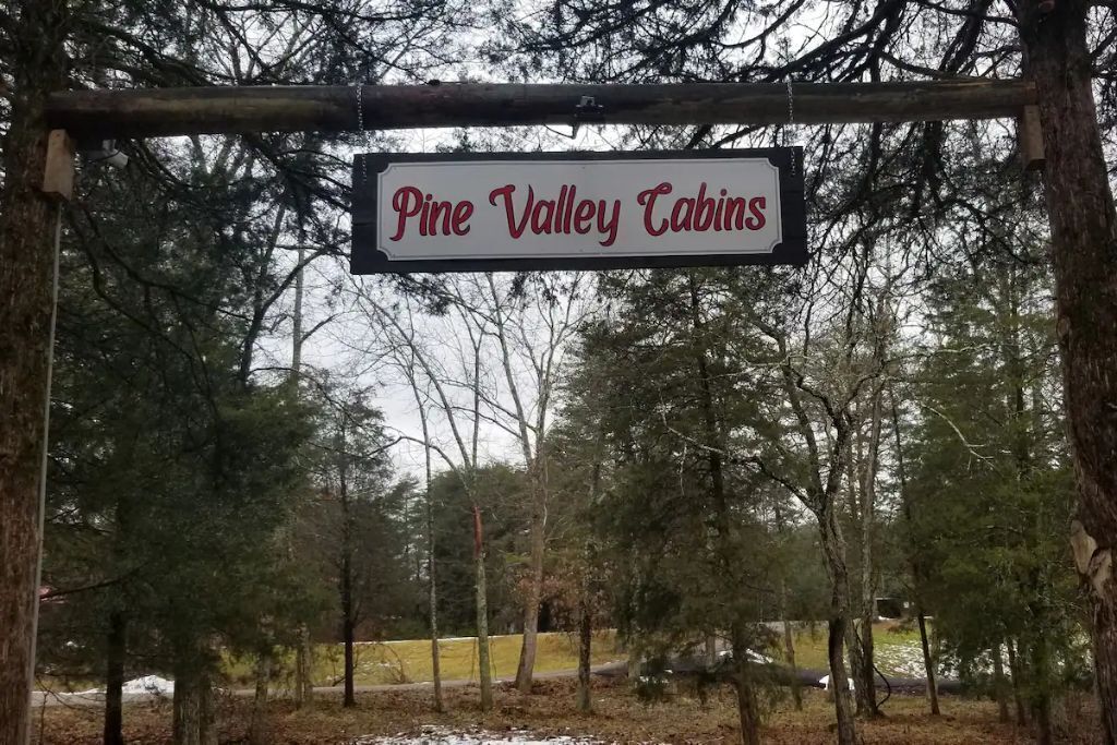 A sign for Pine Valley Cabins.