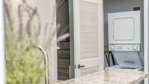 A kitchen with a built-in microwave, a countertop, and a potted plant. - Villas at Seven Dwarfs (Kissimmee)