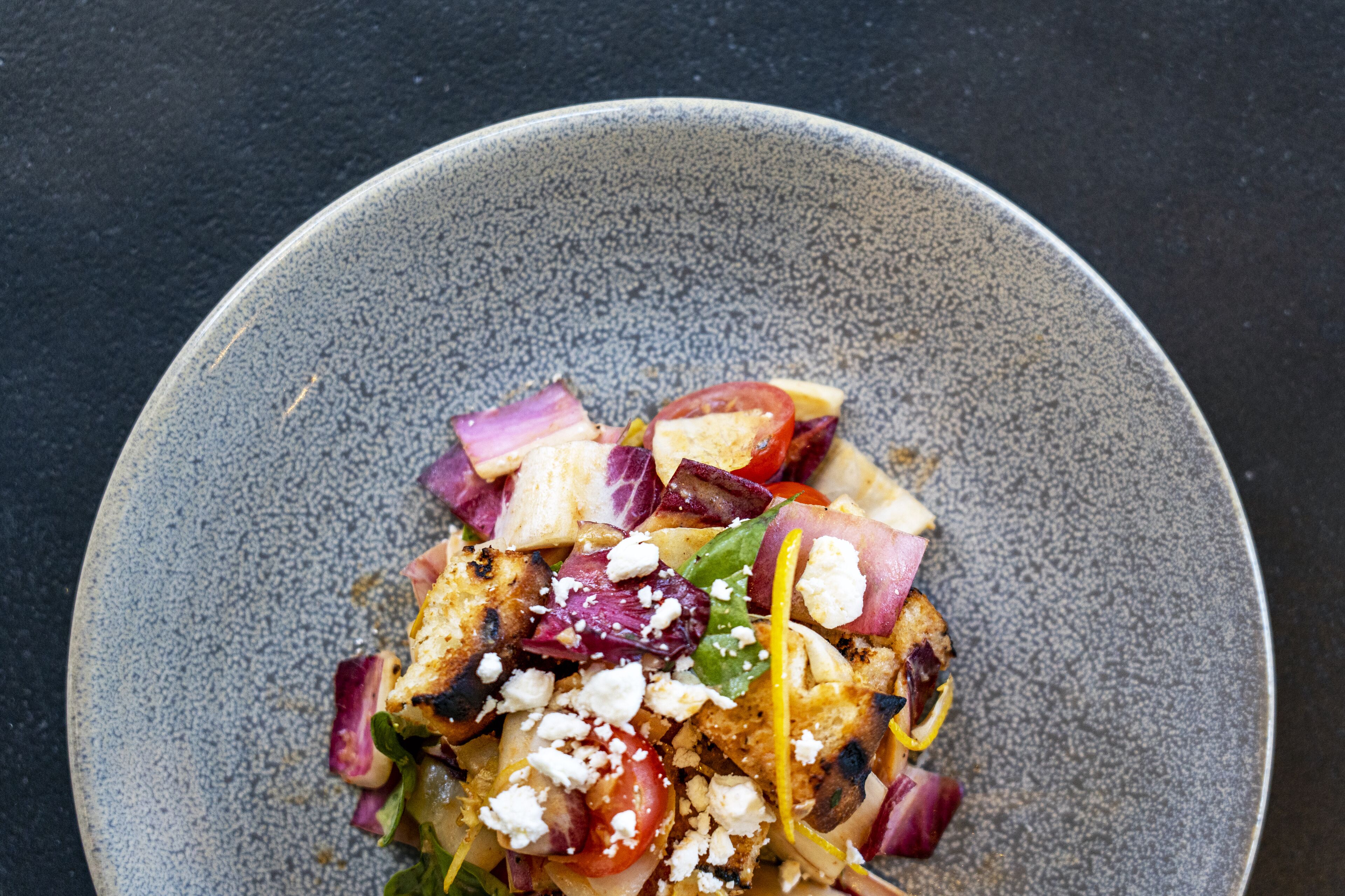 A bowl of salad with various ingredients.