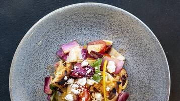 A bowl of salad with various ingredients.