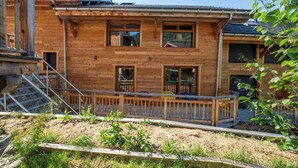 A two-story wooden house with a balcony and a staircase leading to the upper floor. - Chalet Gaïla spacious chalet in Les Allues next to the gondola (Meribel Les Allues)