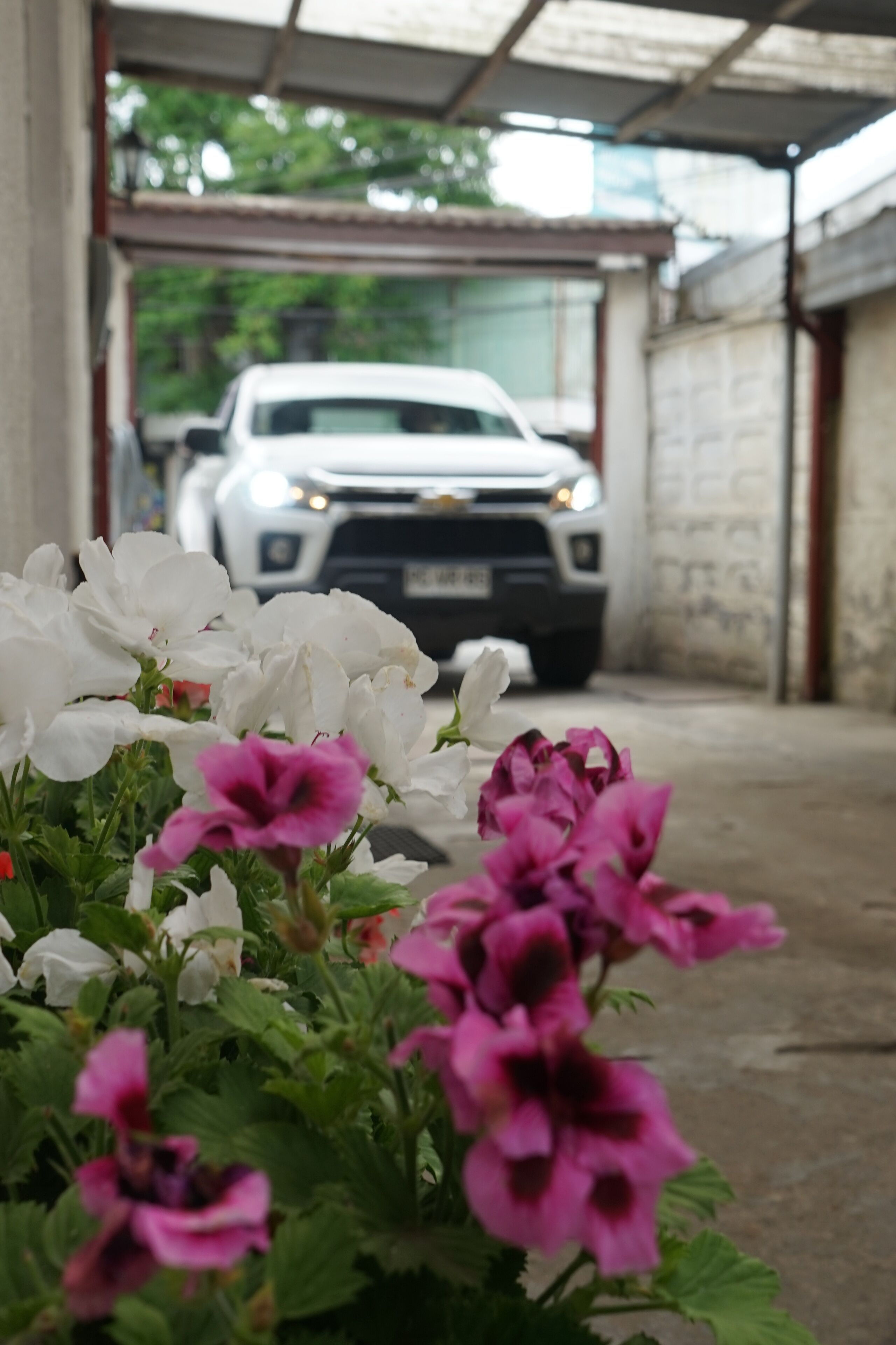 A parking garage with a white car parked in the distance.