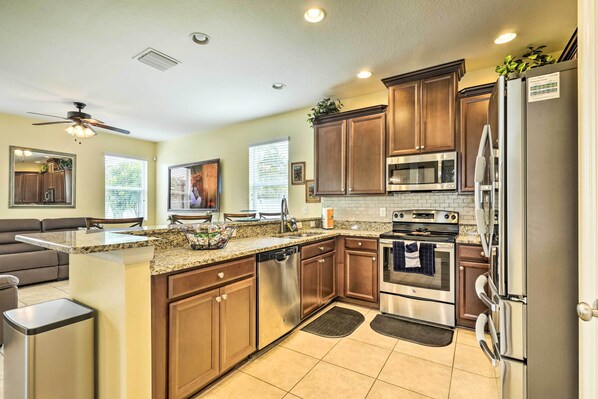 Enjoy cooking in this well-equipped kitchen with a central island, oven, and dishwasher.