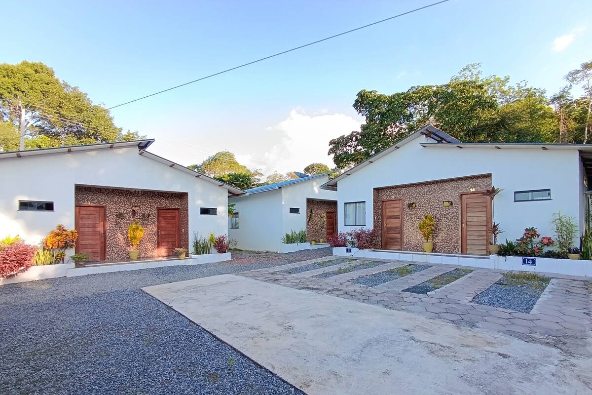 A residential area with two houses, each with a garage door and a small front yard.