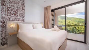 A modern bedroom with a large bed, a nightstand, a wall-mounted light, and a view of a lush landscape through a sliding glass door.