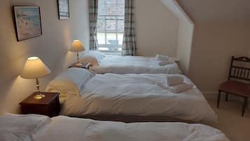 Tabla de planchar con plancha y ropa de cama