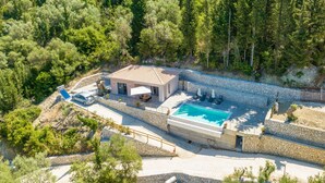 A villa with a swimming pool, stone walls, and a garden. - Gyri Villa, overlooking Vassiliki bay (Lefkada)