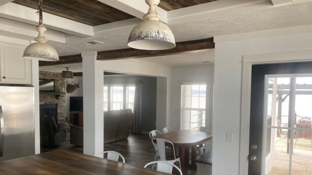 A spacious kitchen with a wooden countertop and white chairs, a dining area with a large table, and a view of the outdoors through a door. - Toledo Bend! Great Fishing with Great Sunsets! (Many)
