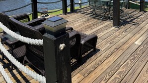 A wooden deck with outdoor furniture, a pergola, and a view of a lake. - Toledo Bend! Great Fishing with Great Sunsets! (Many)