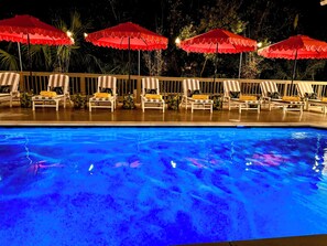 A heated pool, sun loungers