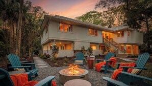 A two-story house with a fire pit and outdoor seating. - Pvt Pool/Spa-Game Room-Theater-Cold Plunge-Sauna-2min Walk to Beach (Hilton Head Island)