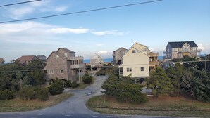 A coastal road with houses on both sides, a clear sky, and a view of the sea. - 500 feet to the Beach, Full house with Stocked Kitchen, Linens & Beach Supplies (Avon)