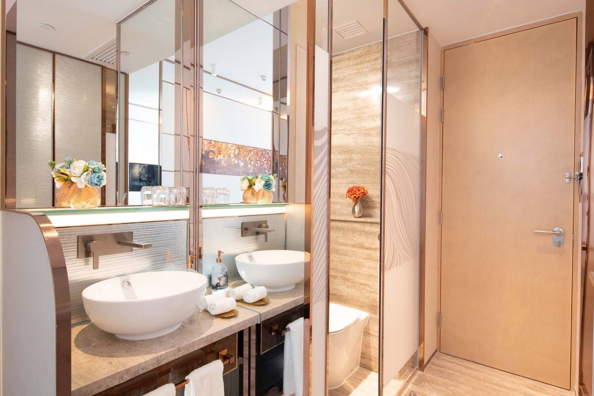 shower, hair dryer, slippers, towels