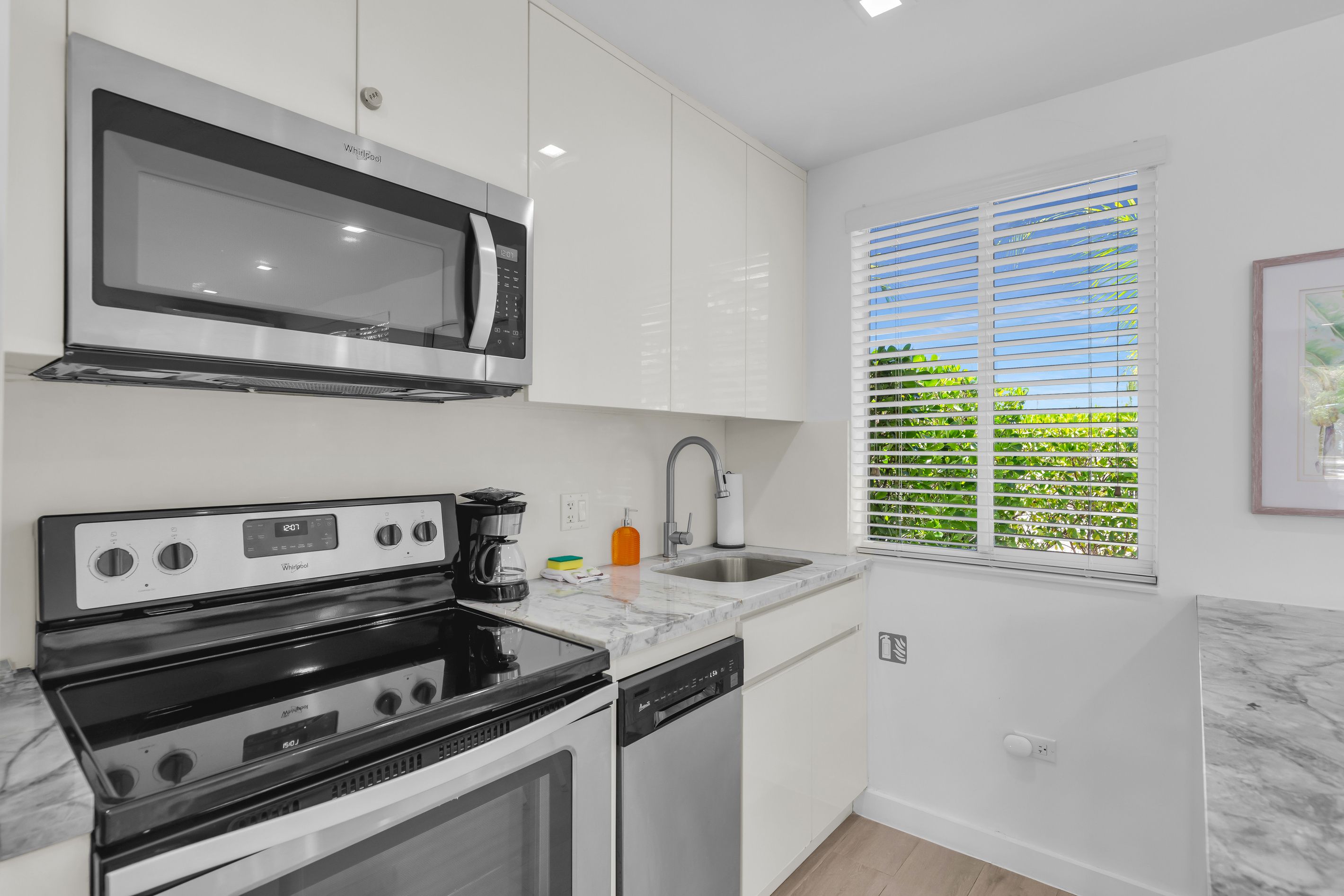 A modern kitchen with a built-in microwave, stove, and dishwasher.