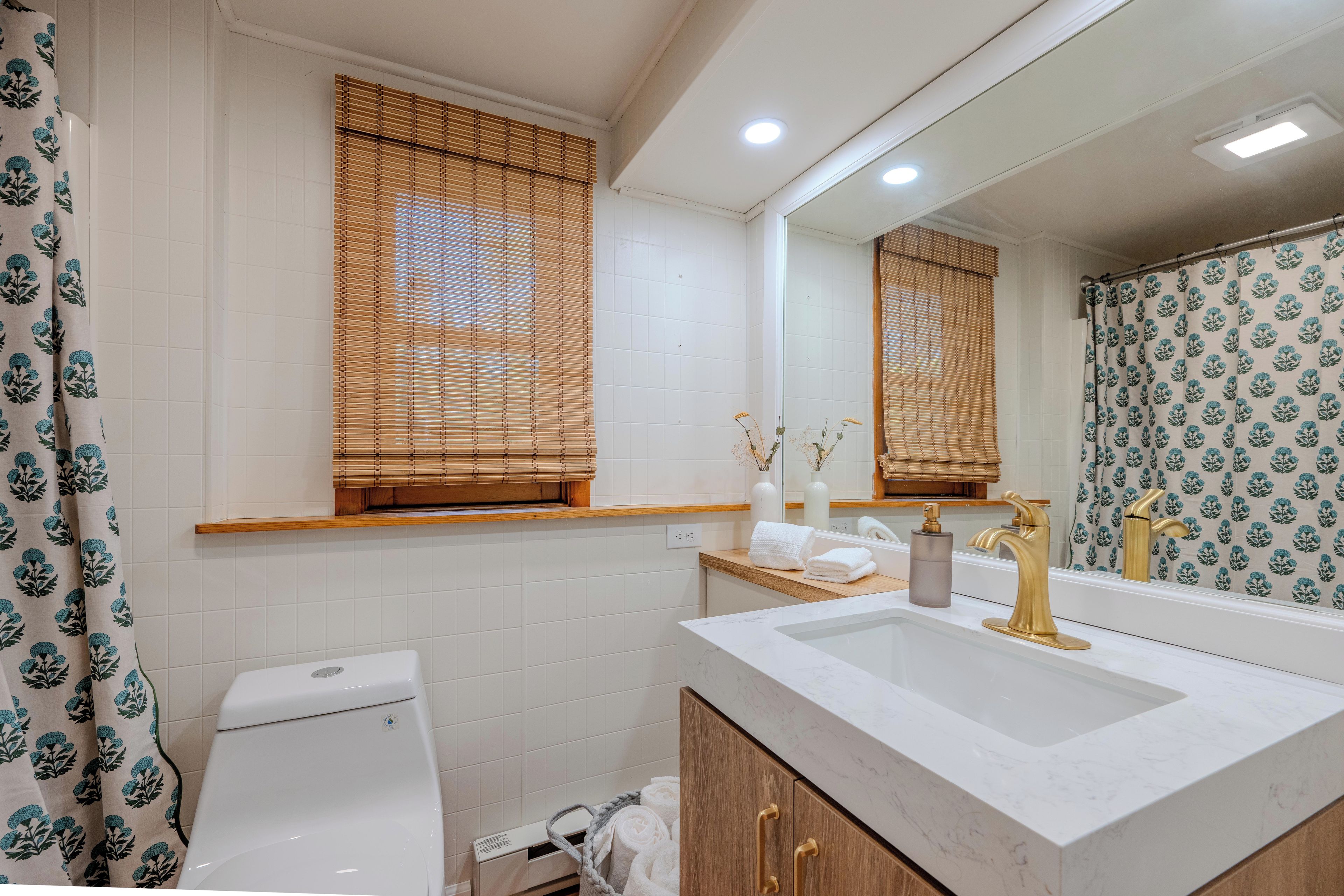 Un baño con inodoro, lavabo y espejo.