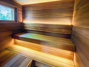 A sauna with wooden walls and a bench. - Tulikettu 1 by Interhome (Pelkosenniemi)