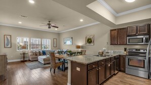 A spacious kitchen with a large island, wooden cabinets, and stainless steel appliances. - Beach Access Condo with Pool and Hot Tub (Miramar Beach)