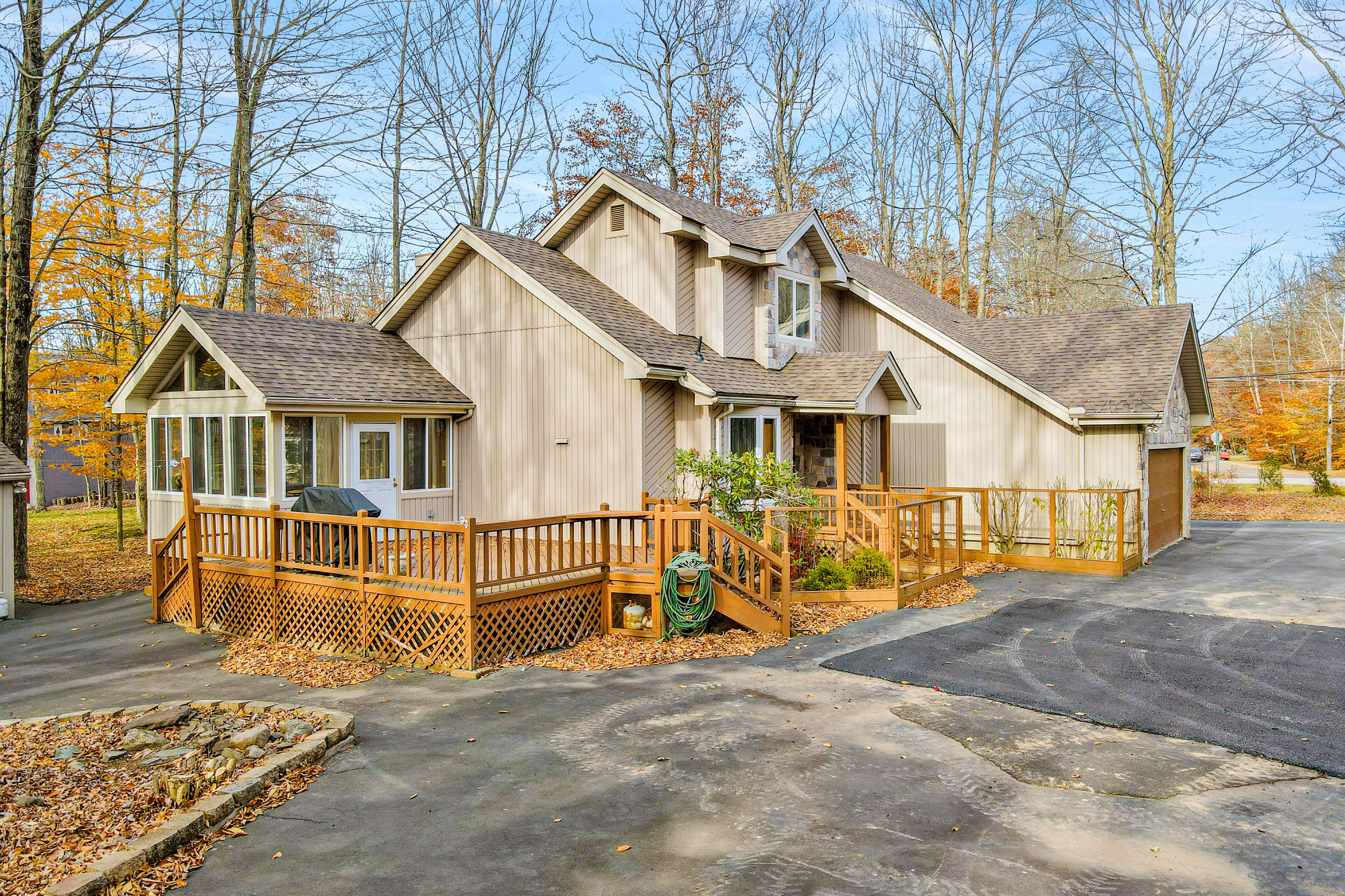 Quiet Poconos retreat with on-site pool, tennis, deck, grill & sun room