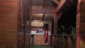 A wooden interior with a central corridor leading to a kitchen area. - Berkey's Jungle Paradise (Roseau)
