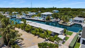 A resort with a marina, swimming pool, and lush greenery.