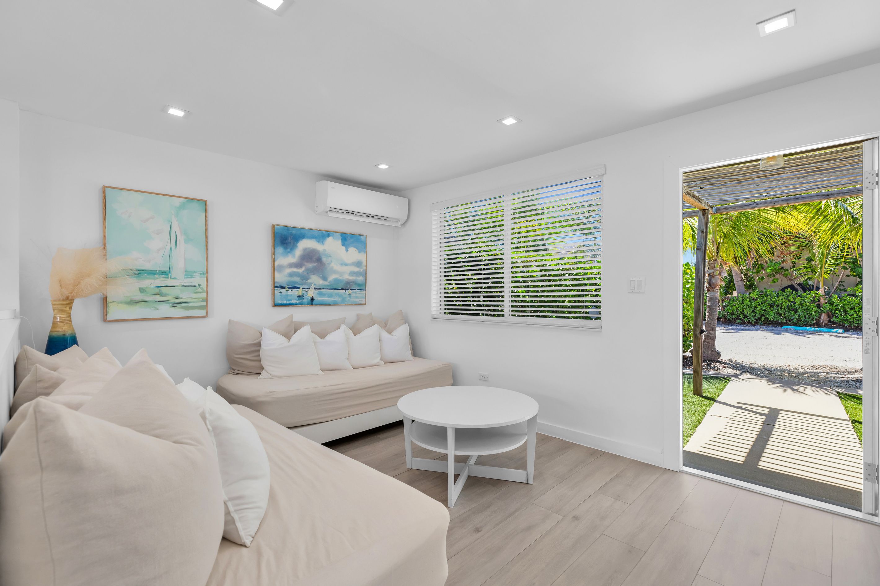 Sink into plush daybed sofas piled with soft pillows at Cabana 3. Framed by coastal art and cooled by quiet split-system AC, this light-filled canal lounge is perfect for unwinding between Florida Keys water adventures.
