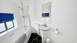 A bathroom with a bathtub, a shower, a sink, and a toilet. - 6 Cross Court, Stafford (Stafford)