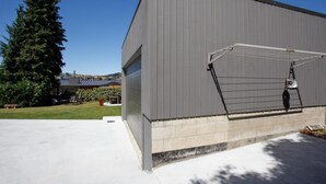 A large industrial building with a covered loading dock and a clear sky. - 1970's Renovated, self contained comfortable 2 bedroom bach (Wanaka)