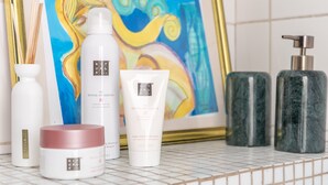 A bathroom shelf with various toiletries including a bottle of body cream, a jar of cream, and a pump bottle. - Vincennes Sauvage  (Vincennes)