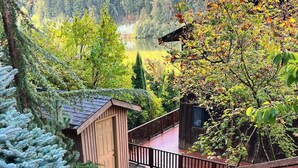 A wooden staircase leading to a deck with a view of a lake and forest. - ~Lakefront Property ~ 23 miles to Mt. Rainier! (Eatonville)