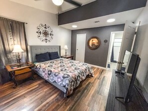 A bedroom with a bed, bedside tables, a lamp, a mirror, and a door. - 2nd floor, 2 bedroom, 2 bathroom unit near Boat Ramp 2 in Canyon Lake! (Canyon Lake)