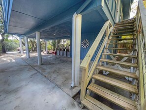 A covered outdoor area with a wooden staircase leading up to a building. - 2nd floor, 2 bedroom, 2 bathroom unit near Boat Ramp 2 in Canyon Lake! (Canyon Lake)