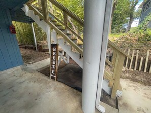 A wooden staircase with a sign that reads "BREEZE" leading to a covered area. - 2nd floor, 2 bedroom, 2 bathroom unit near Boat Ramp 2 in Canyon Lake! (Canyon Lake)
