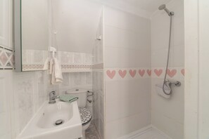 Shower, hair dryer, towels, toilet paper