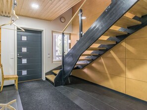 A modern interior with a staircase, a door, and a bench. - Holy rock by Interhome (Pelkosenniemi)