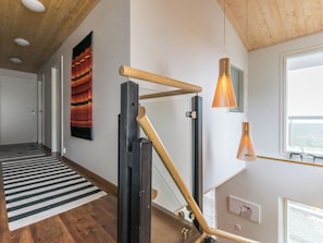 A modern interior with a wooden ceiling, a black and white striped rug, and a wooden climbing structure. - Holy rock by Interhome (Pelkosenniemi)
