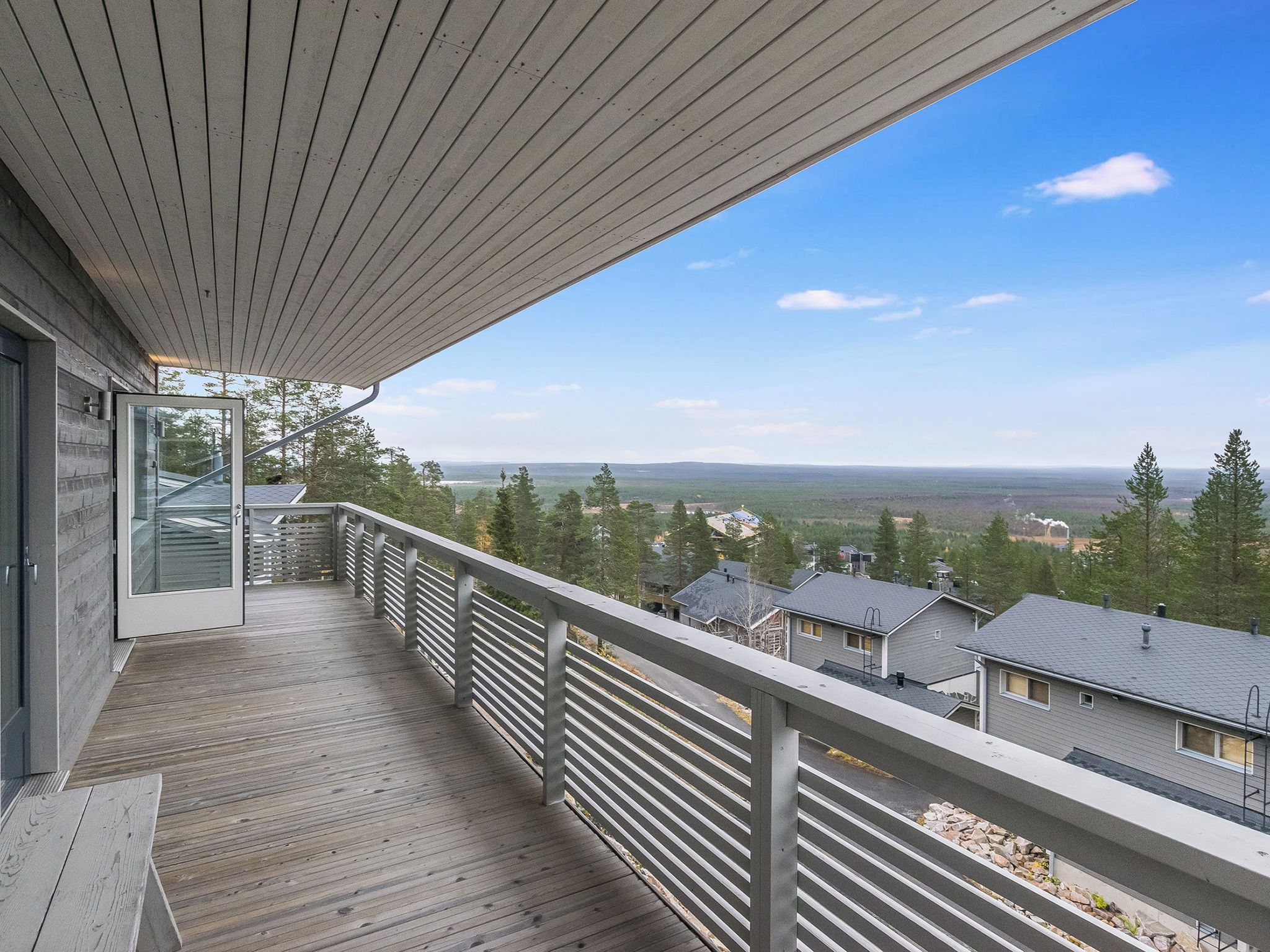 Ein Balkon mit Blick auf ein Wohngebiet und entfernte Berge.
