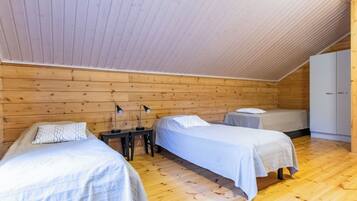 A room with two beds, a desk, and a wardrobe.