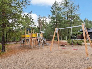 A playground with a slide, swings, and climbing structures.