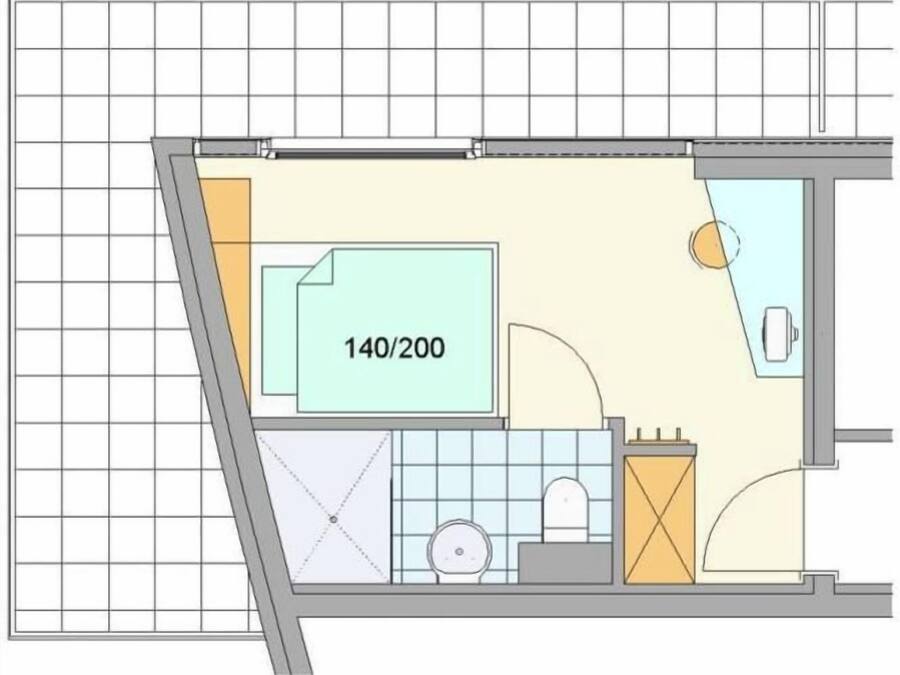 A floor plan of a hotel room with a bathroom, a kitchenette, and a seating area.